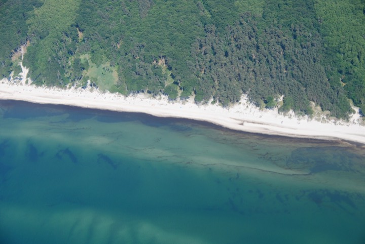 Aerial view of the Weststrand beach with the Darss forest and the turquoise Baltic Sea