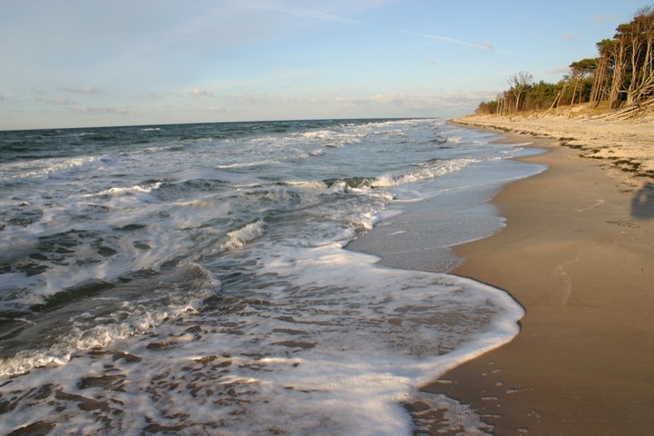 Waves lapping the Weststrand beach in warm evening light