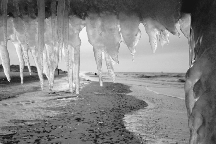 Icicles on the wintry Baltic beach (black-and-white photograph)