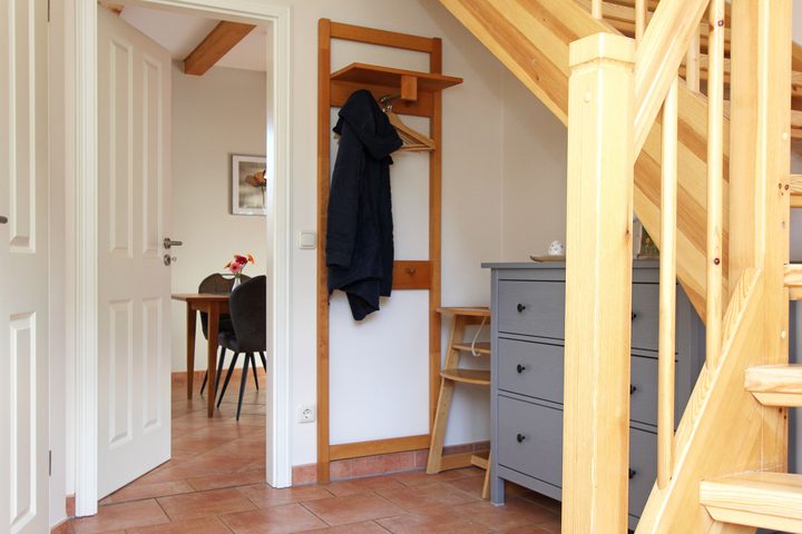 Hallway with coat rack and stairs to the upper floor